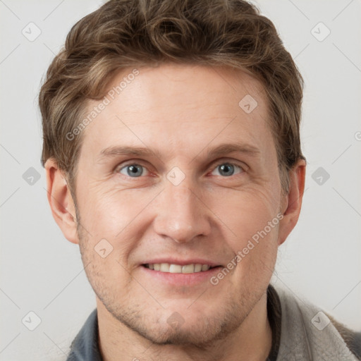 Joyful white adult male with short  brown hair and grey eyes