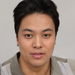 Joyful asian young-adult male with short  brown hair and brown eyes