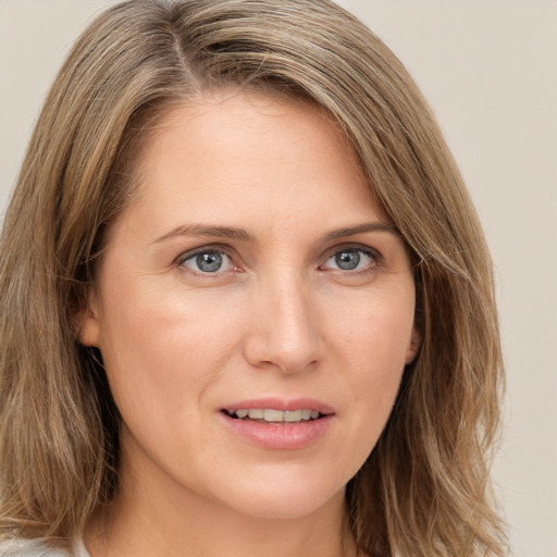 Joyful white young-adult female with long  brown hair and green eyes