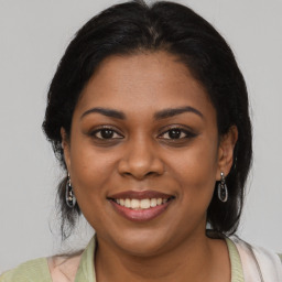 Joyful black young-adult female with medium  brown hair and brown eyes