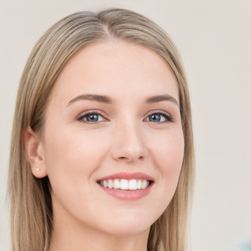 Joyful white young-adult female with long  brown hair and blue eyes