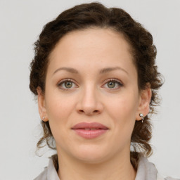 Joyful white young-adult female with medium  brown hair and green eyes