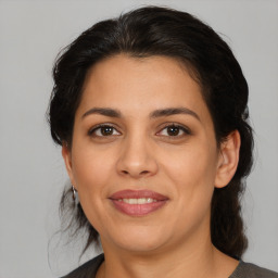 Joyful latino young-adult female with medium  brown hair and brown eyes