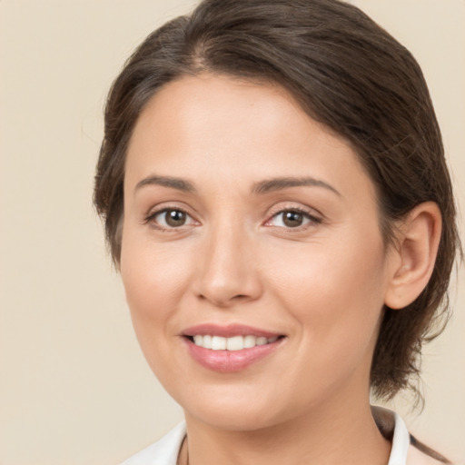 Joyful white young-adult female with medium  brown hair and brown eyes