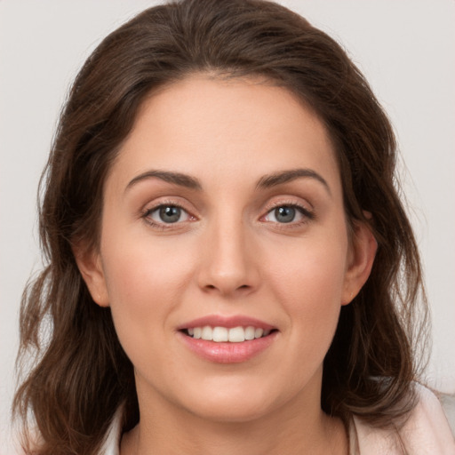 Joyful white young-adult female with long  brown hair and grey eyes