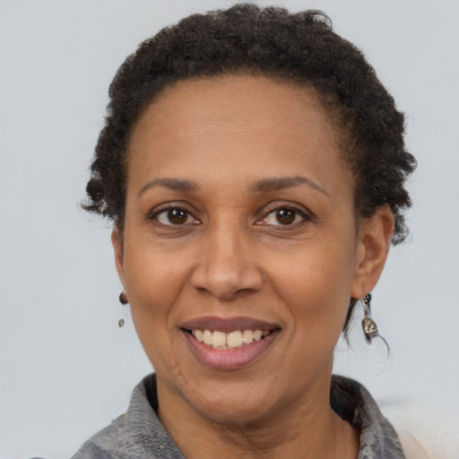 Joyful latino adult female with short  brown hair and brown eyes