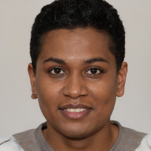 Joyful black young-adult female with short  black hair and brown eyes
