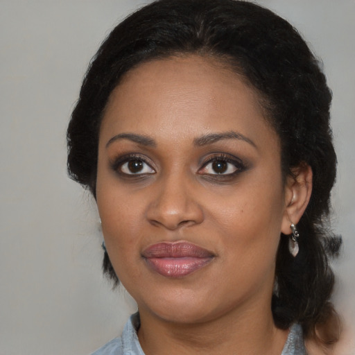 Joyful black young-adult female with medium  brown hair and brown eyes