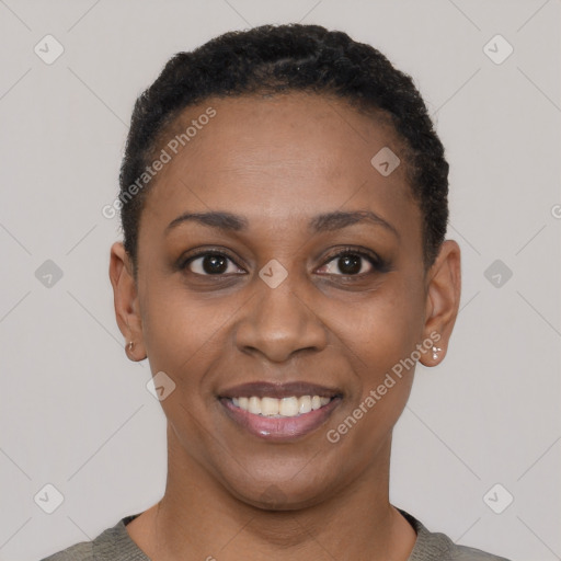 Joyful black young-adult female with short  black hair and brown eyes