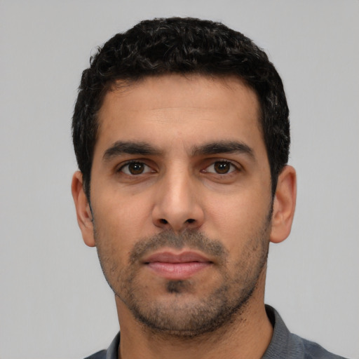 Neutral latino young-adult male with short  black hair and brown eyes