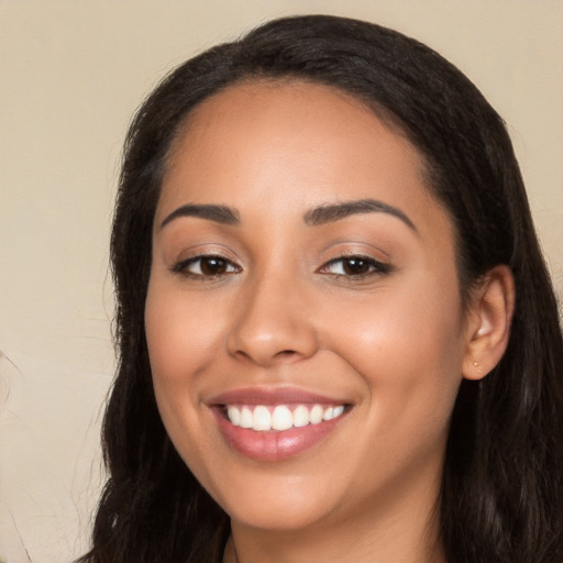 Joyful white young-adult female with long  black hair and brown eyes