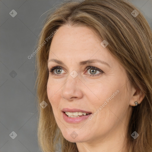 Joyful white adult female with long  brown hair and brown eyes