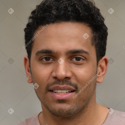 Joyful latino young-adult male with short  black hair and brown eyes