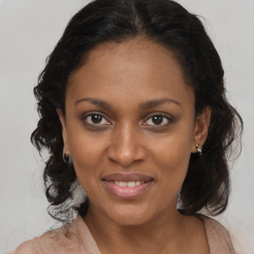 Joyful black young-adult female with medium  brown hair and brown eyes