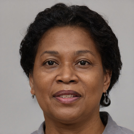Joyful black adult female with short  brown hair and brown eyes