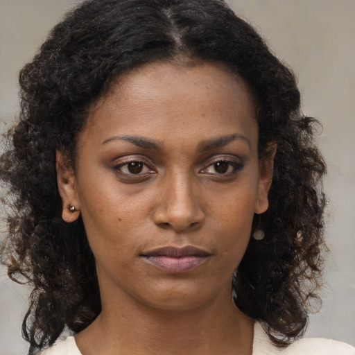 Neutral black young-adult female with medium  brown hair and brown eyes
