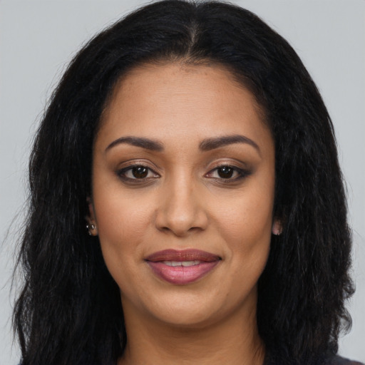 Joyful latino young-adult female with long  black hair and brown eyes