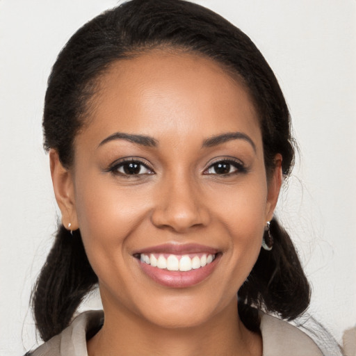 Joyful latino young-adult female with long  brown hair and brown eyes