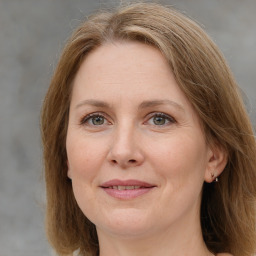 Joyful white adult female with medium  brown hair and grey eyes