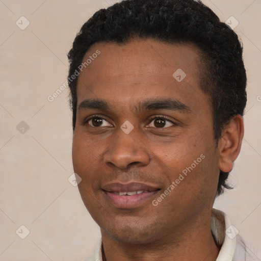 Joyful black young-adult male with short  black hair and brown eyes
