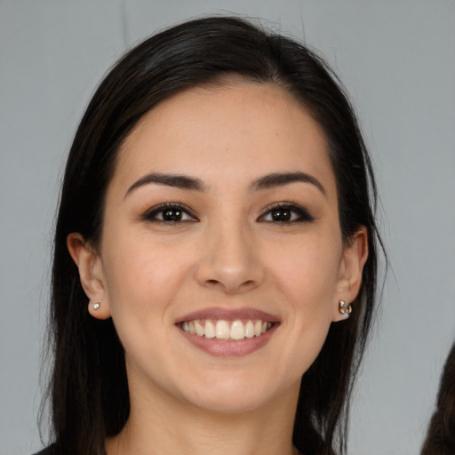 Joyful white young-adult female with long  brown hair and brown eyes