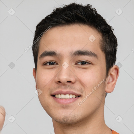 Joyful white young-adult male with short  black hair and brown eyes