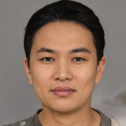 Joyful asian young-adult male with short  black hair and brown eyes