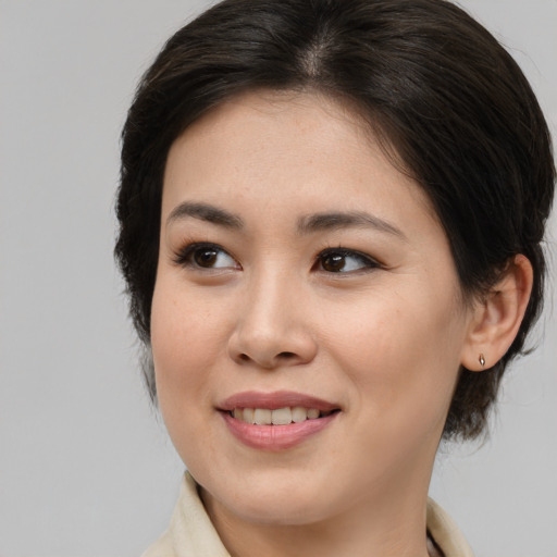 Joyful white young-adult female with medium  brown hair and brown eyes