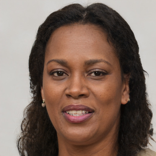 Joyful black adult female with long  brown hair and brown eyes