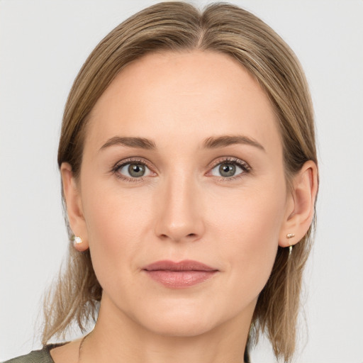 Joyful white young-adult female with medium  brown hair and grey eyes