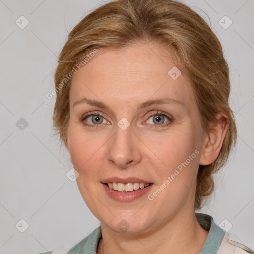 Joyful white adult female with medium  brown hair and blue eyes