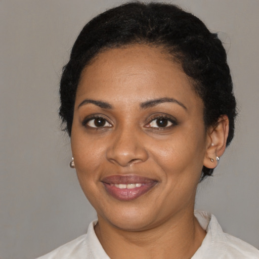 Joyful black adult female with short  black hair and brown eyes