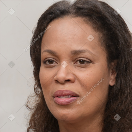 Joyful white adult female with long  brown hair and brown eyes