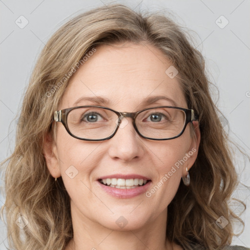 Joyful white adult female with medium  brown hair and blue eyes