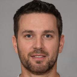 Joyful white young-adult male with short  brown hair and brown eyes