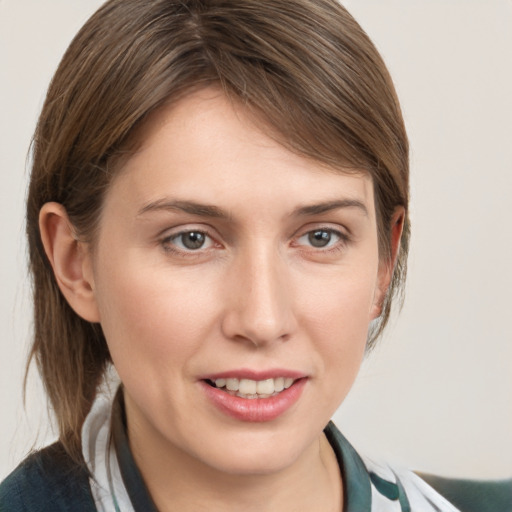 Joyful white young-adult female with medium  brown hair and grey eyes