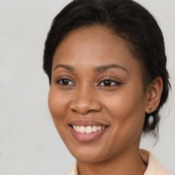 Joyful black young-adult female with medium  brown hair and brown eyes