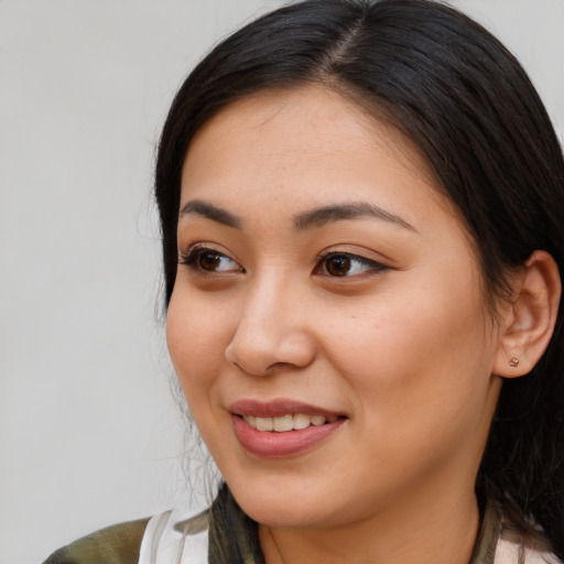 Joyful asian young-adult female with medium  brown hair and brown eyes