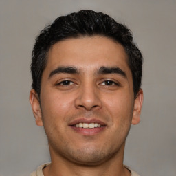 Joyful latino young-adult male with short  brown hair and brown eyes