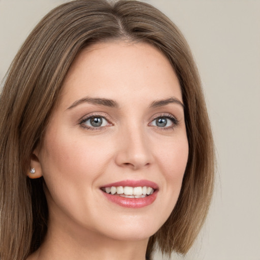 Joyful white young-adult female with long  brown hair and green eyes