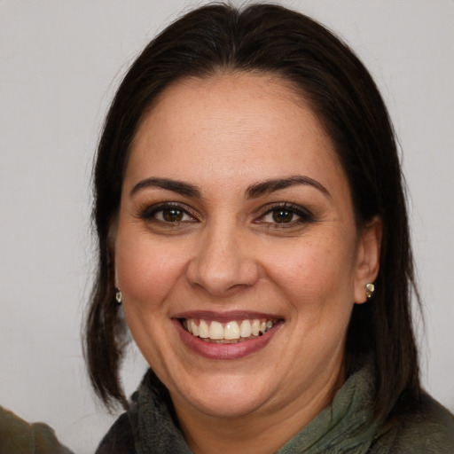 Joyful white adult female with medium  brown hair and brown eyes