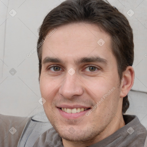 Joyful white adult male with short  brown hair and brown eyes