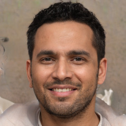 Joyful white young-adult male with short  black hair and brown eyes