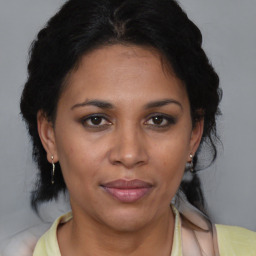 Joyful black adult female with medium  brown hair and brown eyes