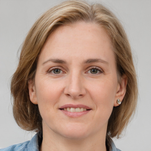 Joyful white young-adult female with medium  brown hair and blue eyes