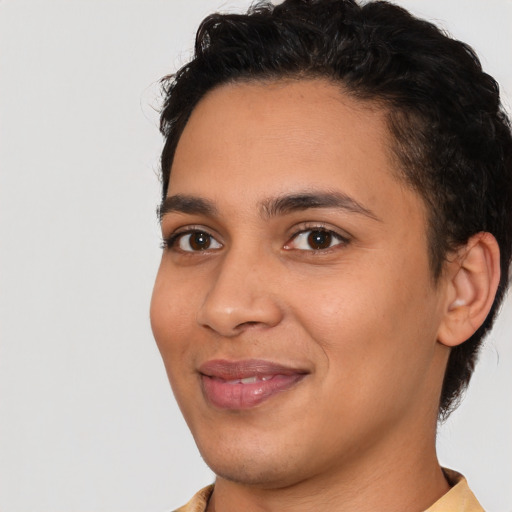 Joyful latino young-adult female with short  black hair and brown eyes