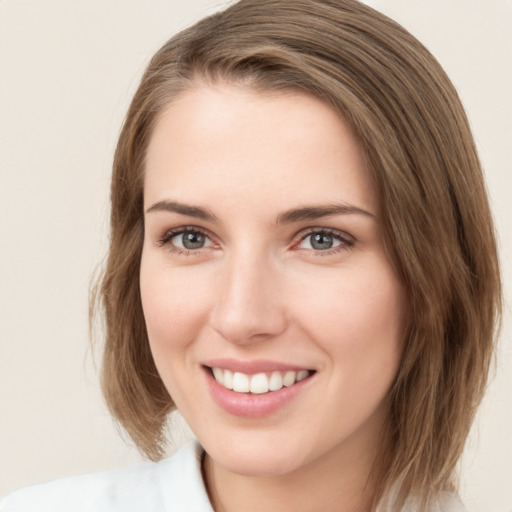 Joyful white young-adult female with medium  brown hair and green eyes