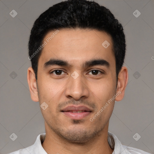 Joyful latino young-adult male with short  black hair and brown eyes