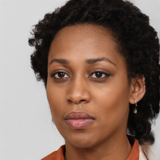 Neutral black young-adult female with long  brown hair and brown eyes