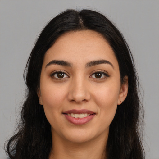 Joyful latino young-adult female with long  brown hair and brown eyes